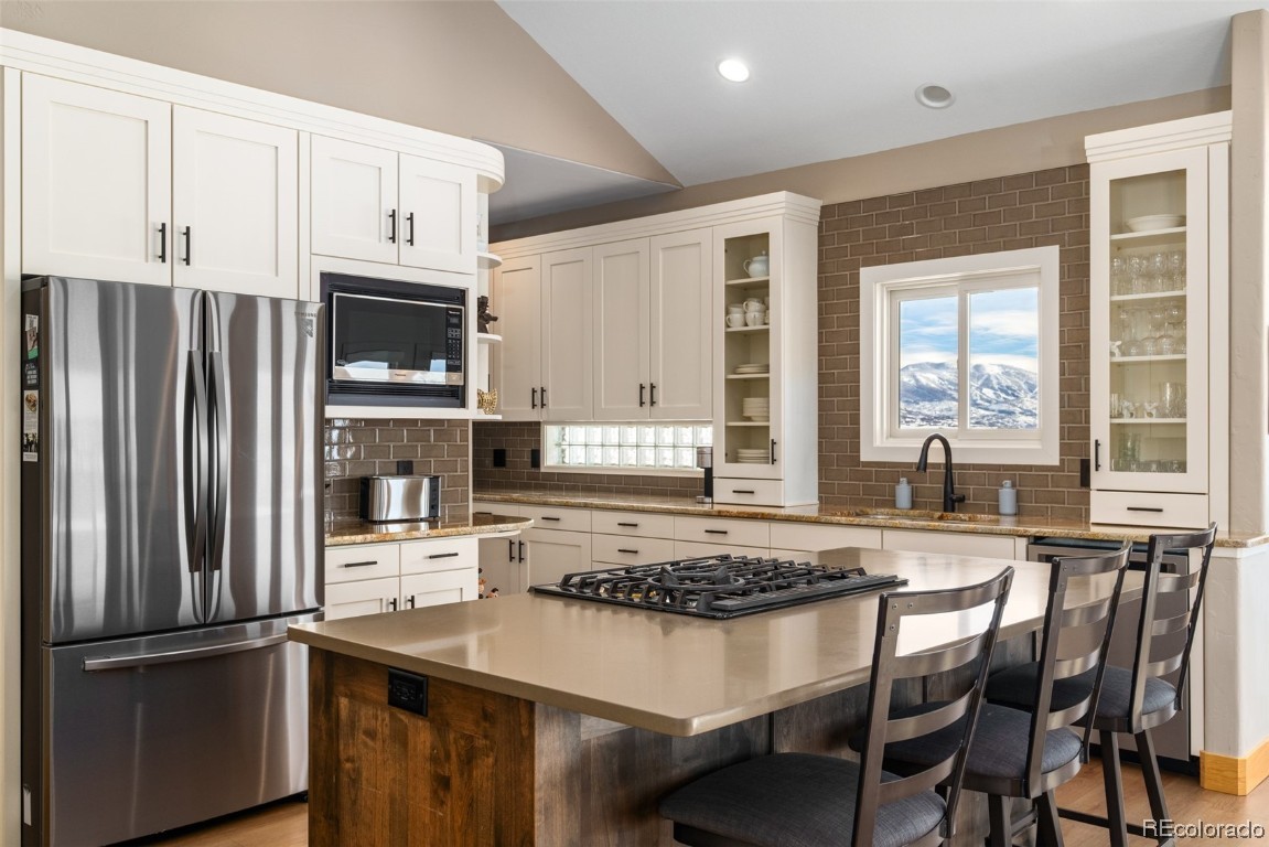 43750 Diamondback Way Steamboat Springs, CO 80487 - Photo 15 of 50 a kitchen with stainless steel appliances granite countertop a stove a refrigerator and a microwave