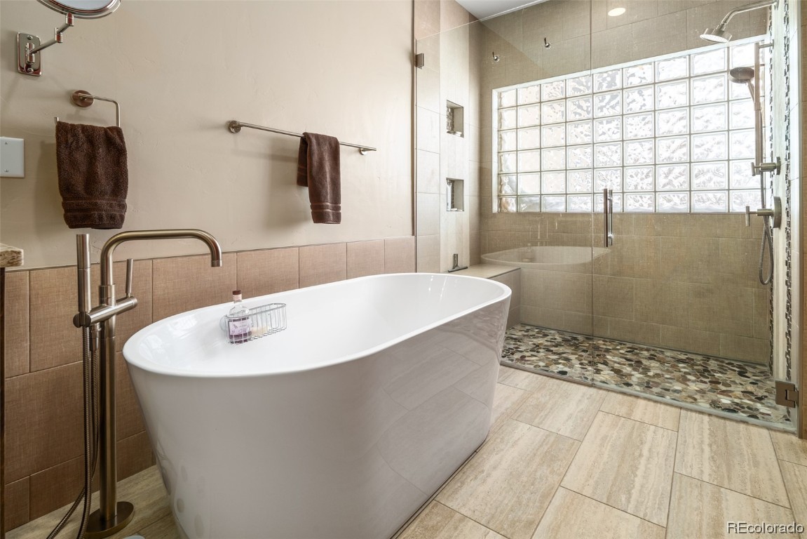 43750 Diamondback Way Steamboat Springs, CO 80487 - Photo 17 of 50 a bathroom with a bathtub and shower