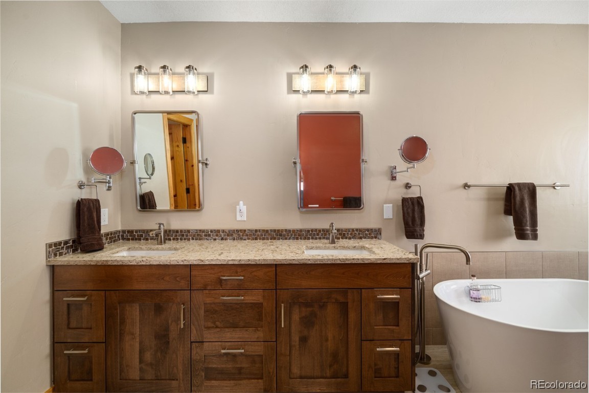 43750 Diamondback Way Steamboat Springs, CO 80487 - Photo 18 of 50 a bathroom with a double vanity sink and a mirror