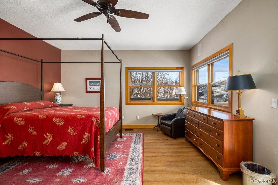 43750 Diamondback Way Steamboat Springs, CO 80487 - Photo 20 of 50 a bedroom with a bed and wooden floor