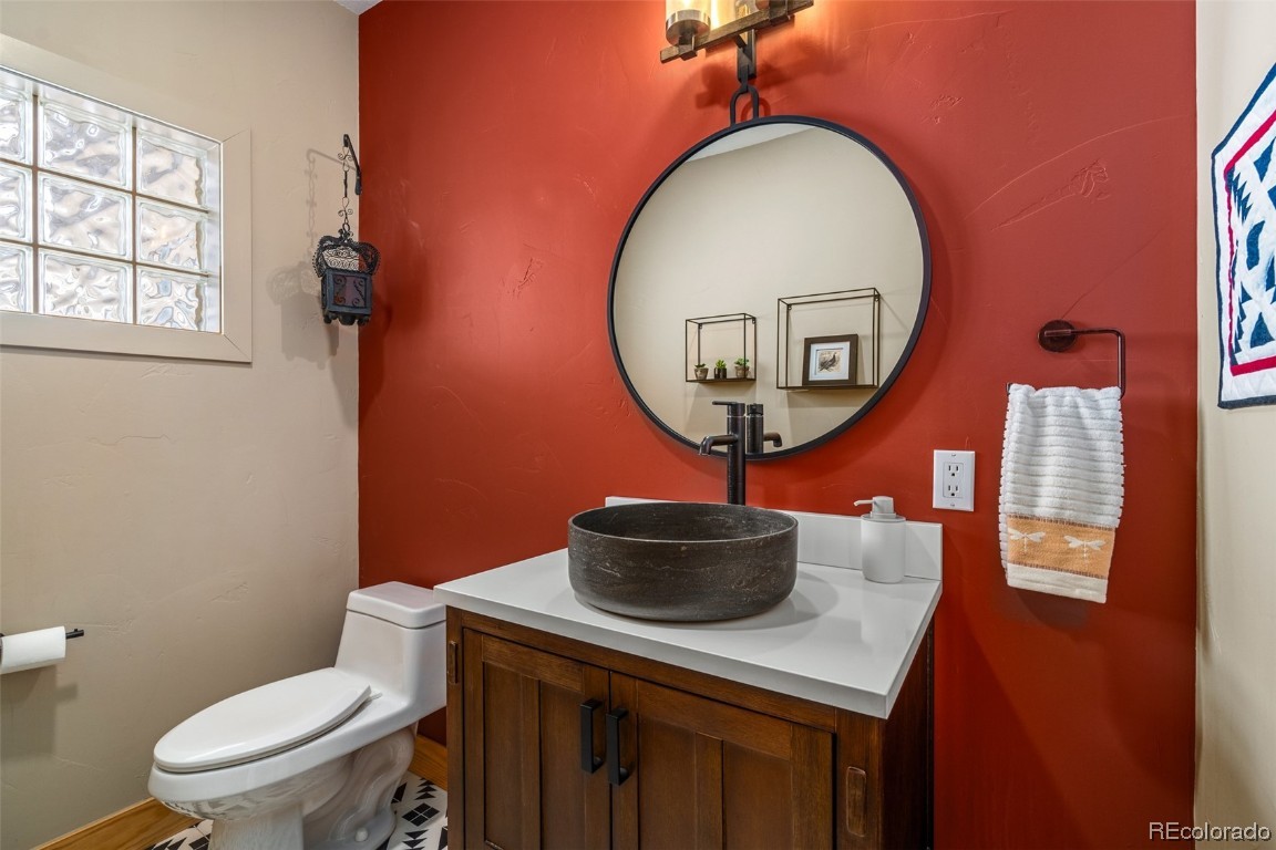 43750 Diamondback Way Steamboat Springs, CO 80487 - Photo 24 of 50 a bathroom with a toilet a sink and a mirror
