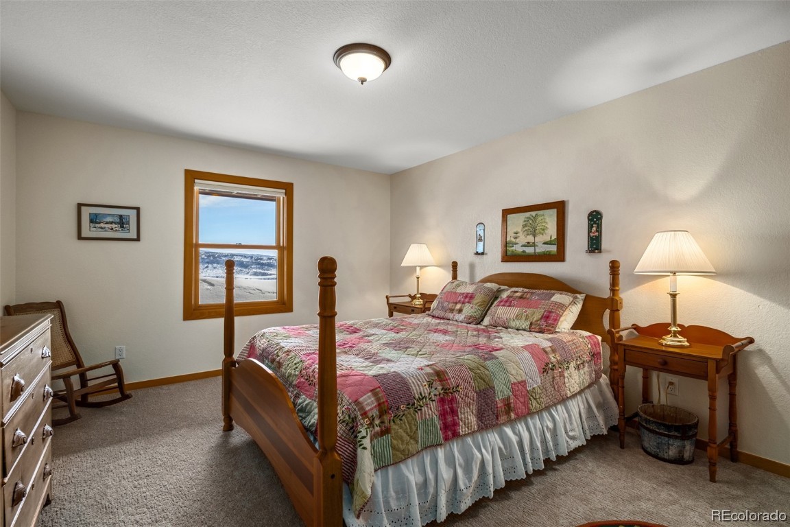 43750 Diamondback Way Steamboat Springs, CO 80487 - Photo 32 of 50 a bedroom with a bed and a lamp