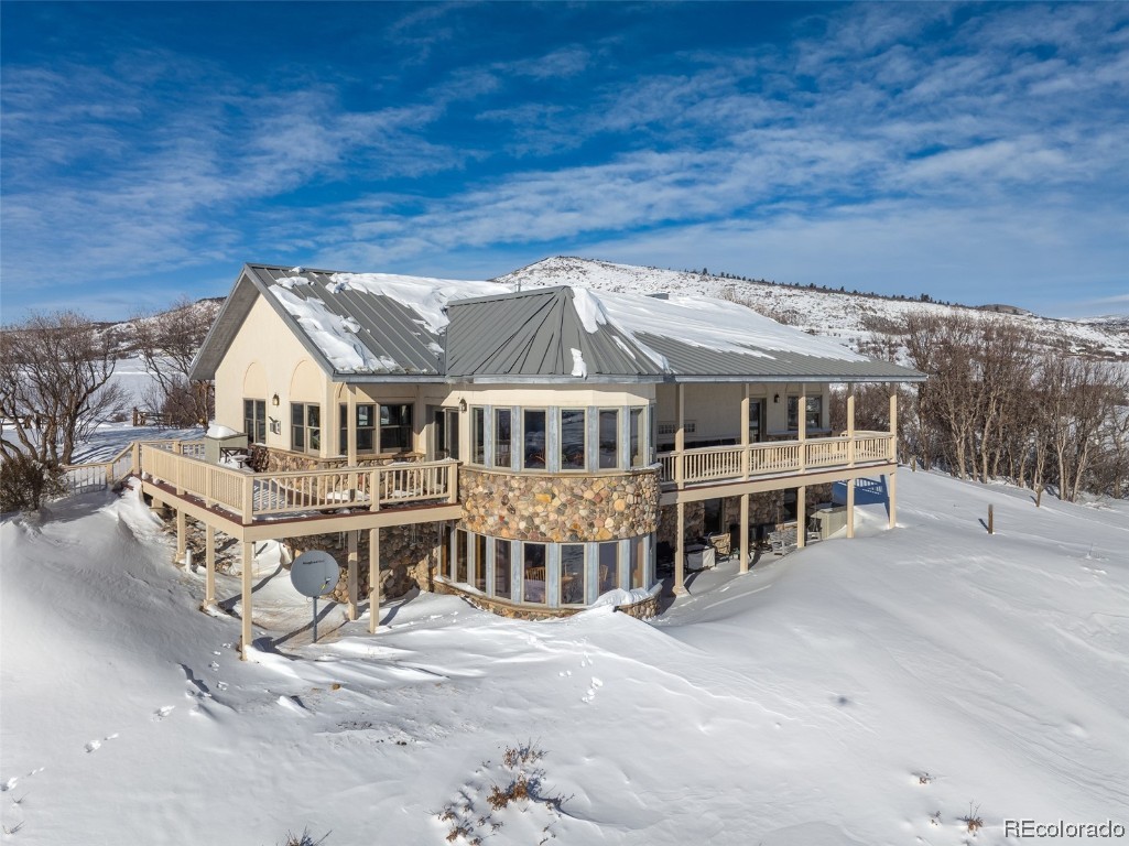 43750 Diamondback Way Steamboat Springs, CO 80487 - Photo 48 of 50 a view of house with a wooden deck and a big yard