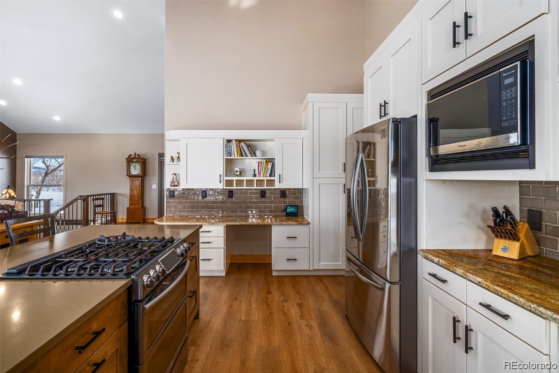 43750 Diamondback Way Steamboat Springs, CO 80487 - Photo 10 of 50 a kitchen with stainless steel appliances a stove cabinets and wooden floor