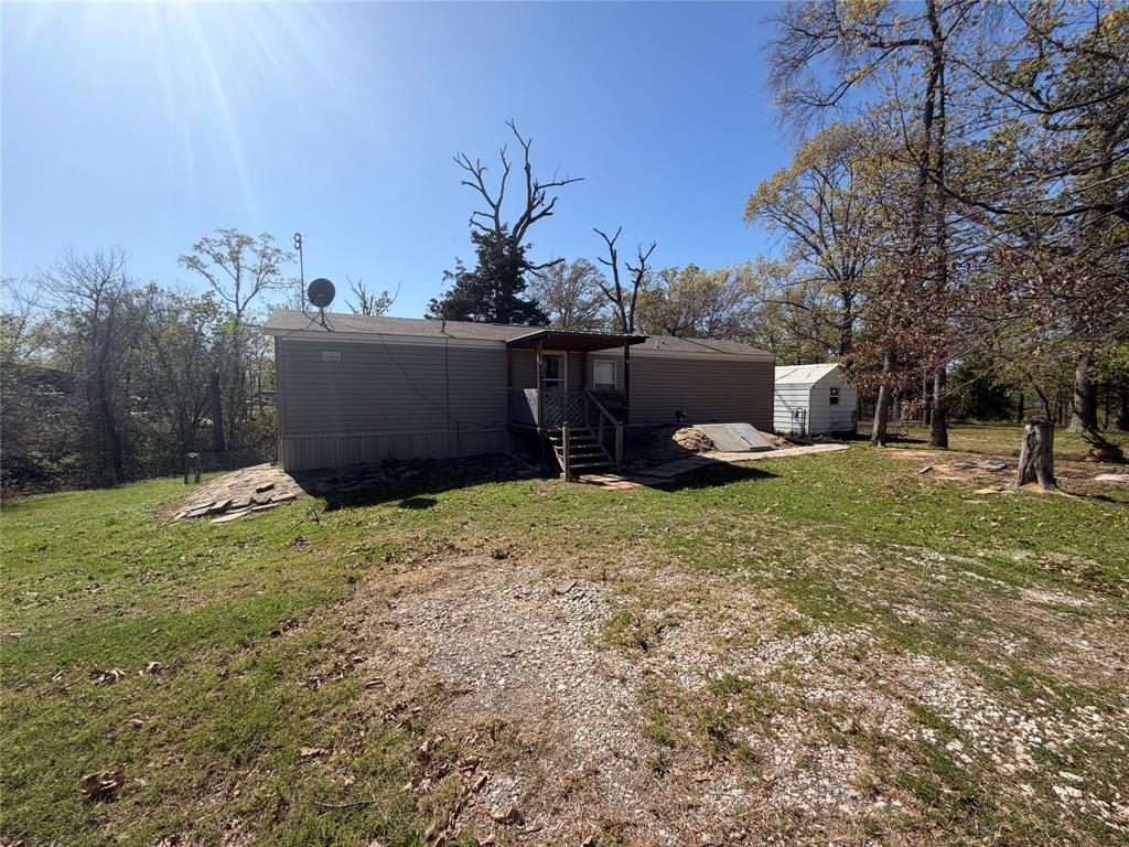 985 Indian Gap Quitman, TX 75783 - Photo 2 of 20 a backyard of a house with plants and trees
