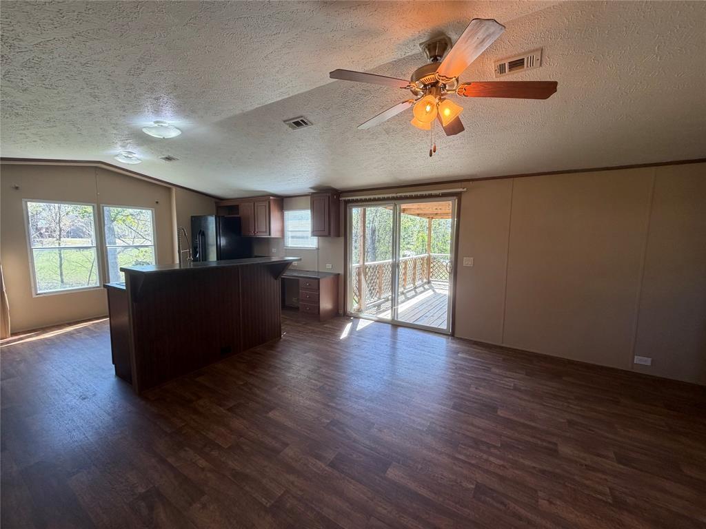 985 Indian Gap Quitman, TX 75783 - Photo 5 of 20 a view of a livingroom with furniture a ceiling fan and wooden floor