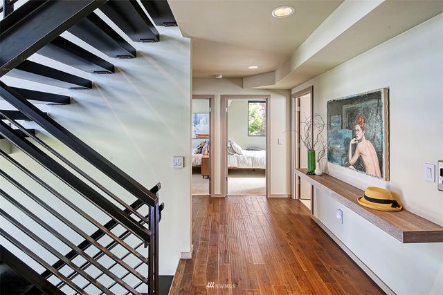 a bedroom with a bed and a large window with outer view