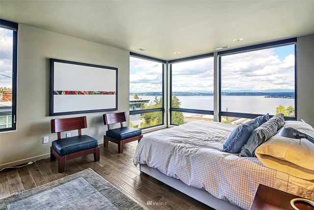 a large bedroom with a bed and glass window