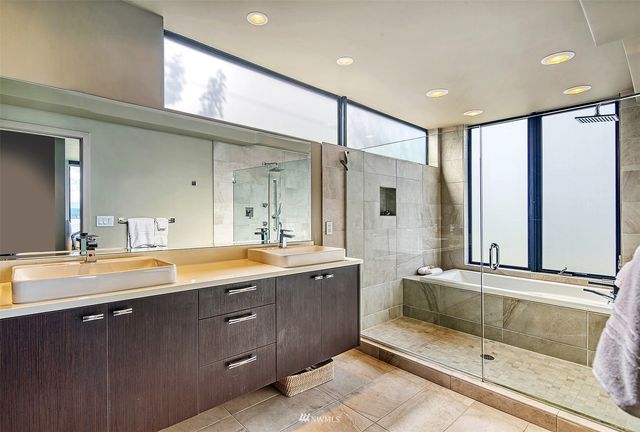 a bathroom with a bathtub and a shower