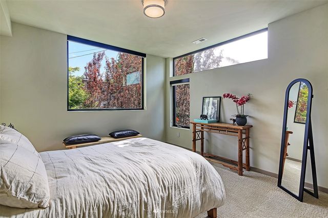 a bedroom with a bed and a painting on the wall