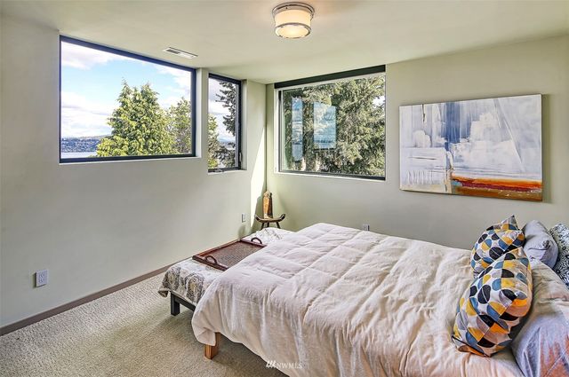a bathroom with a bathtub shower sink vanity mirror and toilet