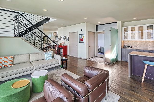 a living room with furniture and stairs