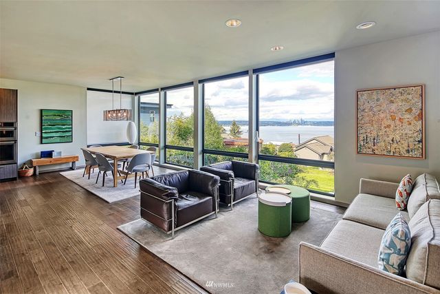 a living room with furniture and a floor to ceiling window
