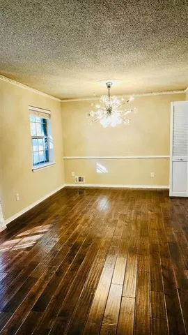 a view of a room with wooden floor
