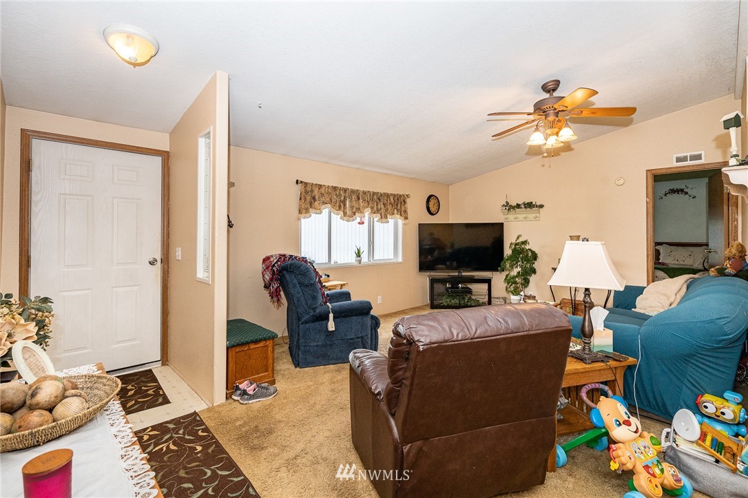 368 Jones Road Winlock, WA 98596 - Photo 12 of 39 a living room with furniture a flat screen tv and a fireplace