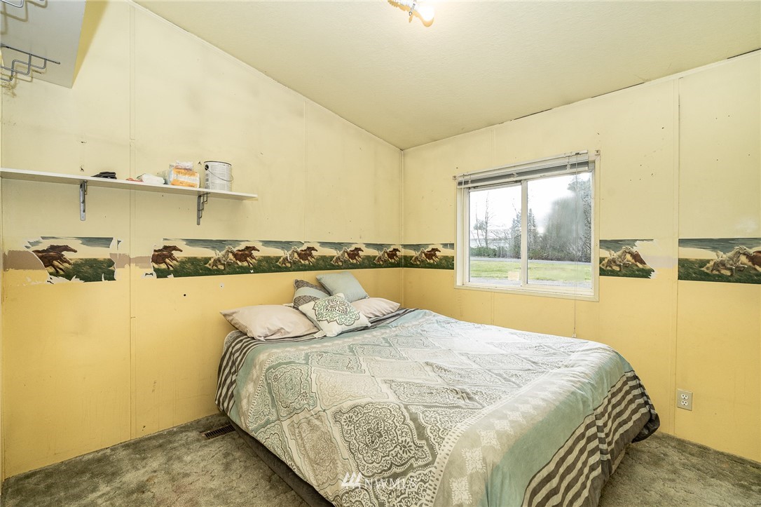 368 Jones Road Winlock, WA 98596 - Photo 24 of 39 a bed sitting in a bedroom next to a bathroom