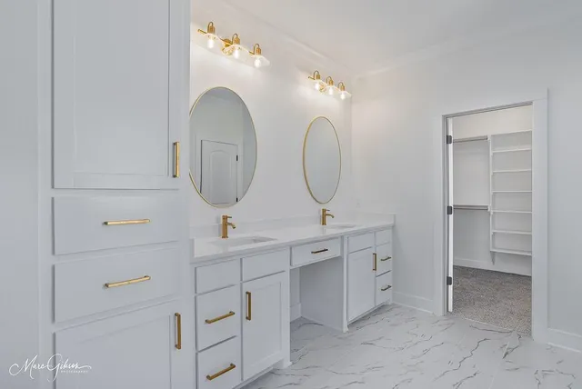 a bathroom with a double vanity sink and a mirror
