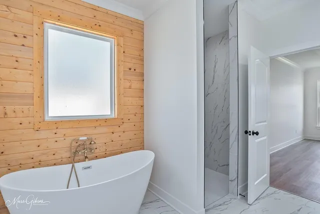 a bathroom with a tub and shower