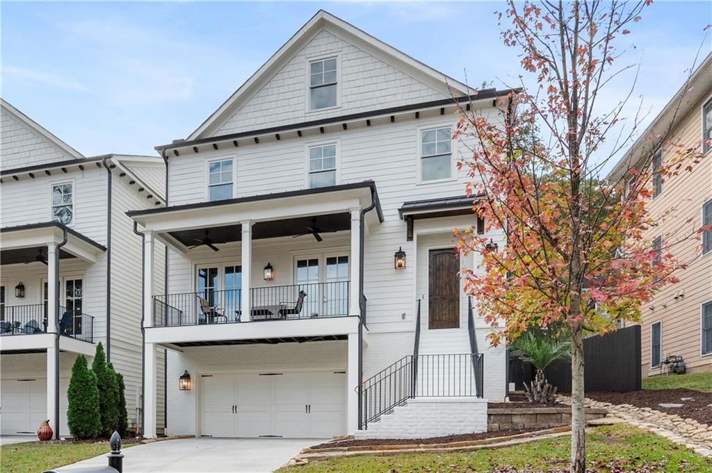 633 Timm Valley Road Northeast Atlanta, GA 30305 - Photo 1 of 1 View of front facade with a garage and a balcony