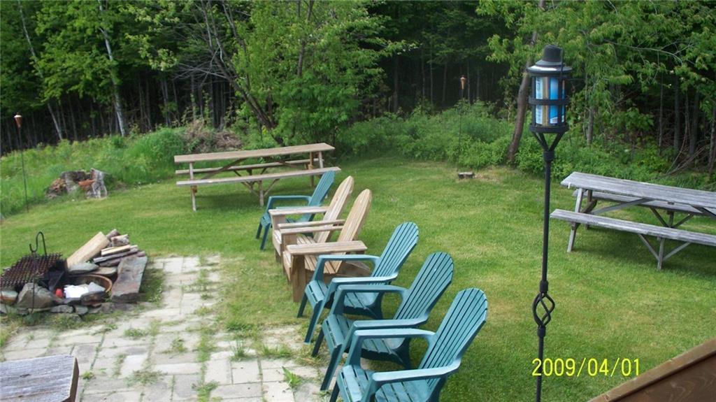 183 Wilsons Mill Road Rangeley, ME 04970 - Photo 14 of 32 side yard and fire pit
