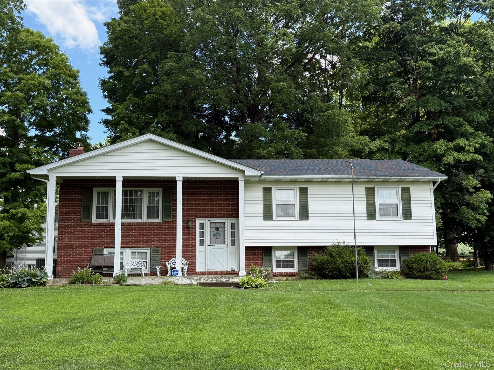 a front view of a house with a garden