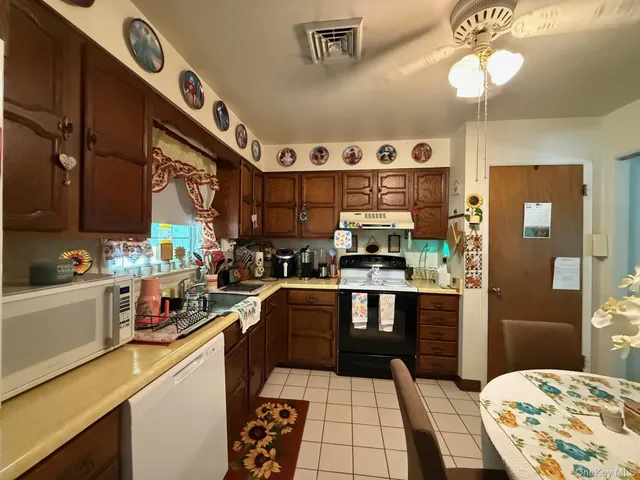 a kitchen with stainless steel appliances a stove a sink and cabinets
