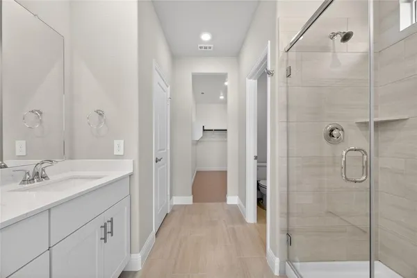 a spacious bathroom with a shower and a sink
