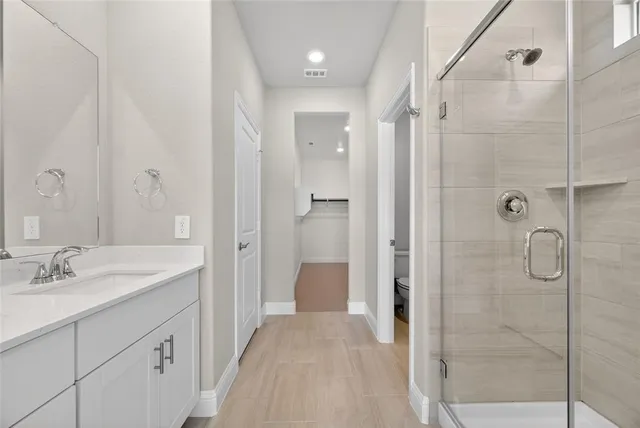 a spacious bathroom with a shower and a sink