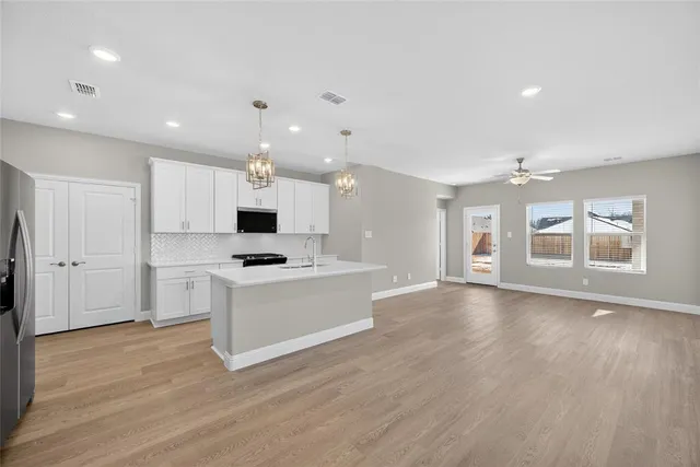 a view of kitchen with sink and microwave