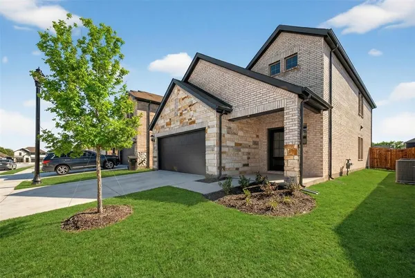 a view of a chair and table in backyard of the house