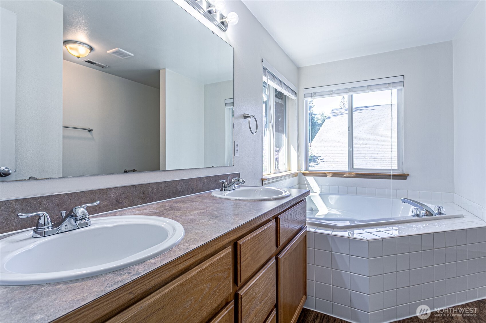 8342 49th Loop Southeast Olympia, WA 98513 - Photo 13 of 24 a bathroom with a sink tub double vanity and mirror