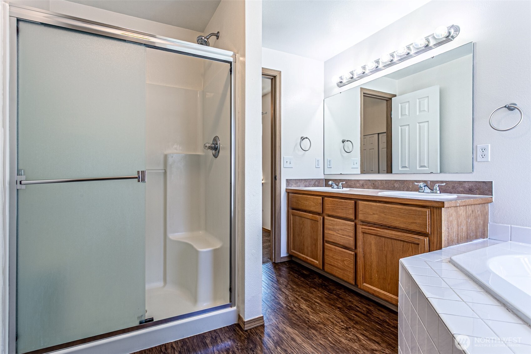 8342 49th Loop Southeast Olympia, WA 98513 - Photo 14 of 24 a bathroom with a shower sink and mirror