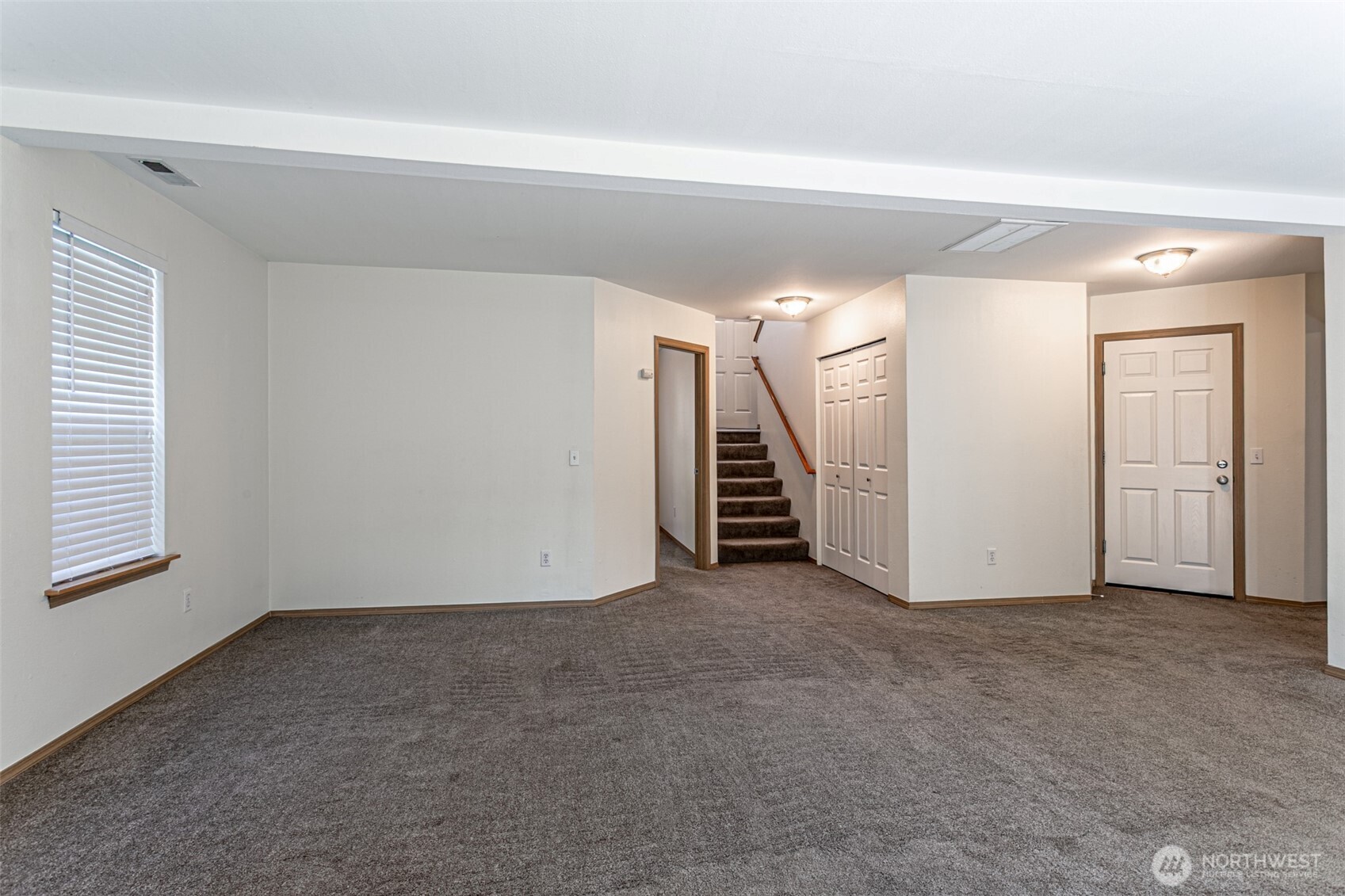 8342 49th Loop Southeast Olympia, WA 98513 - Photo 18 of 24 an empty room with stairs and a window