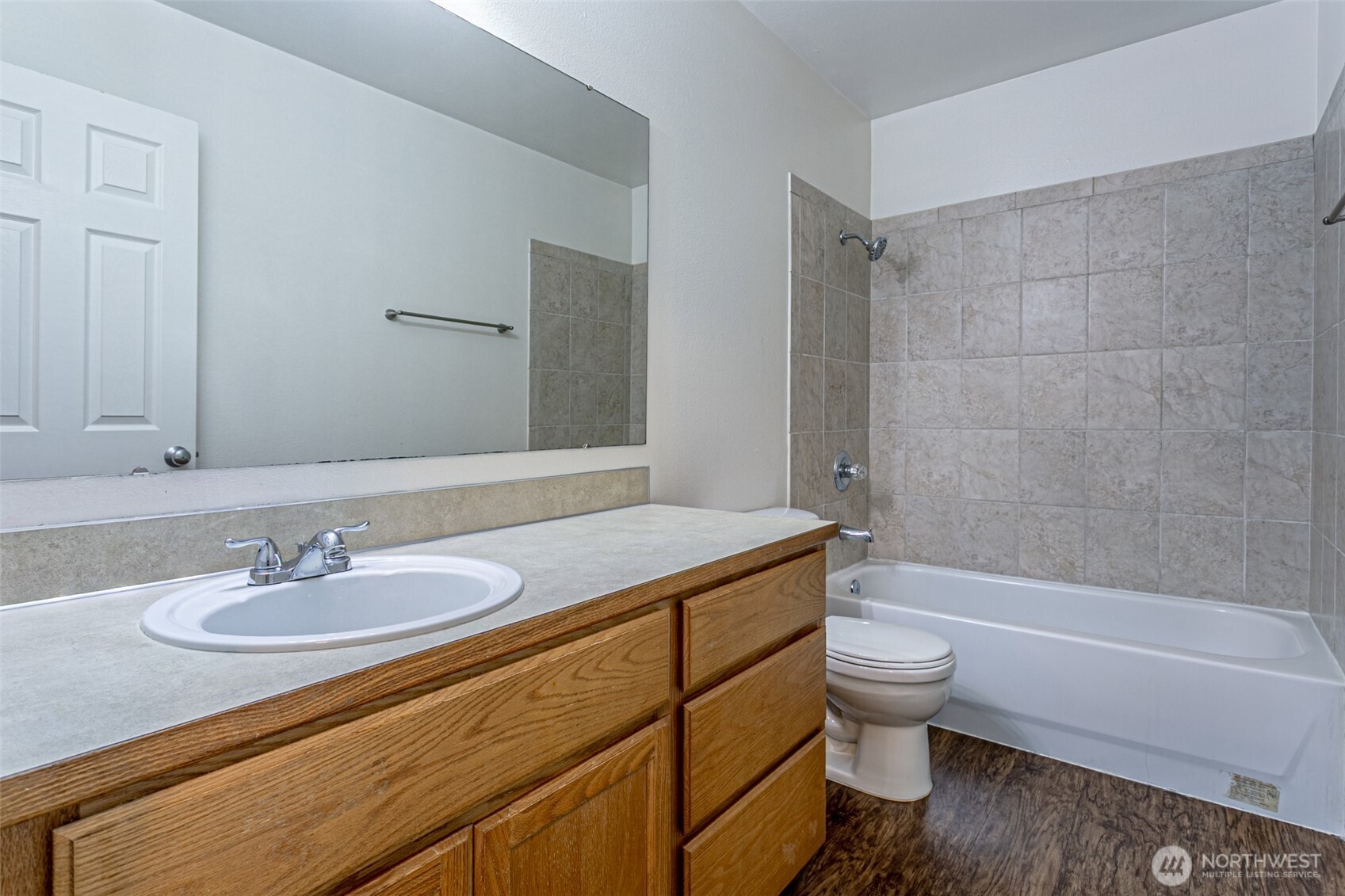 8342 49th Loop Southeast Olympia, WA 98513 - Photo 21 of 24 a bathroom with a granite countertop sink a toilet and bathtub