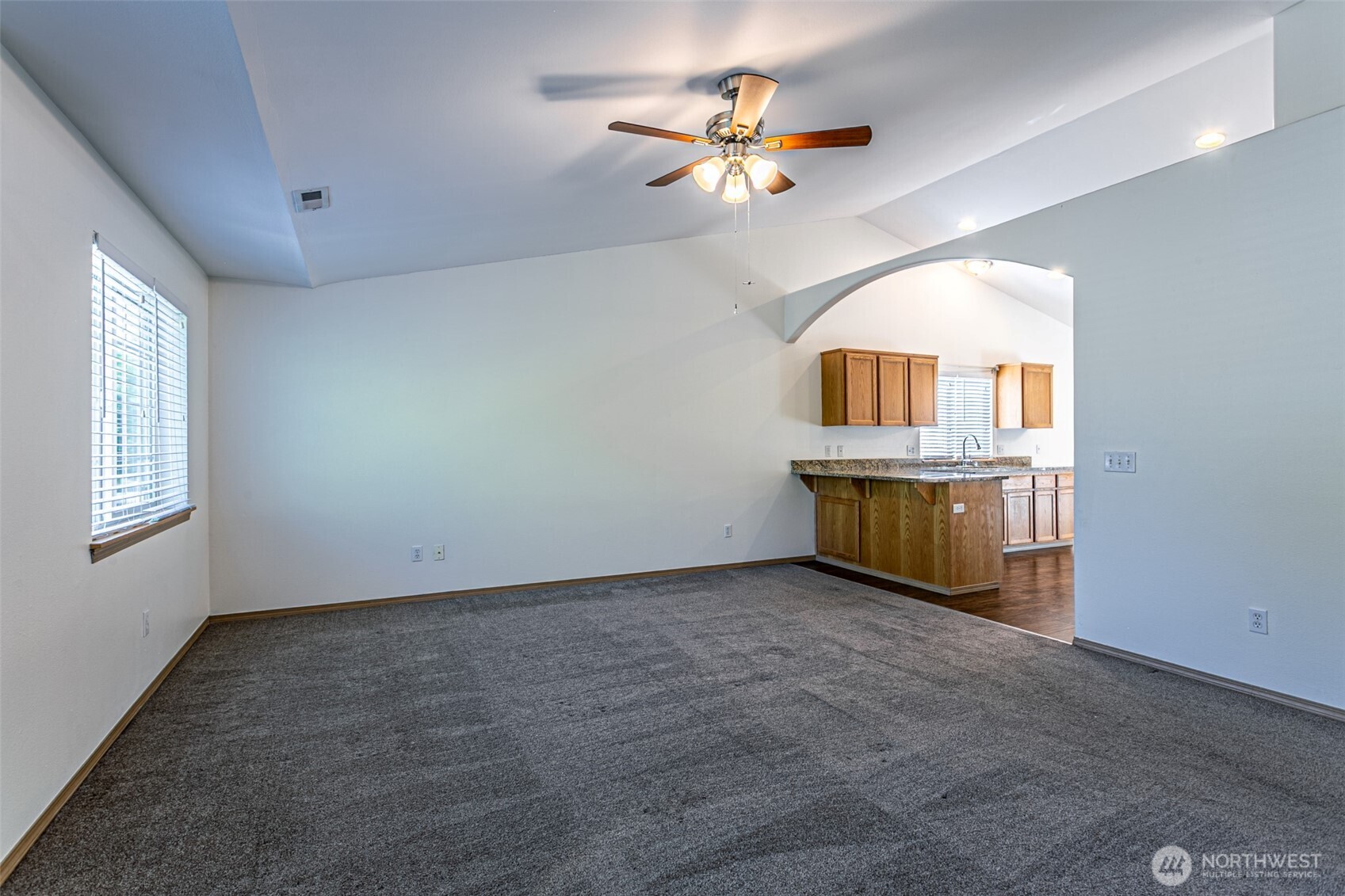 8342 49th Loop Southeast Olympia, WA 98513 - Photo 5 of 24 an empty room with a chandelier fan and windows