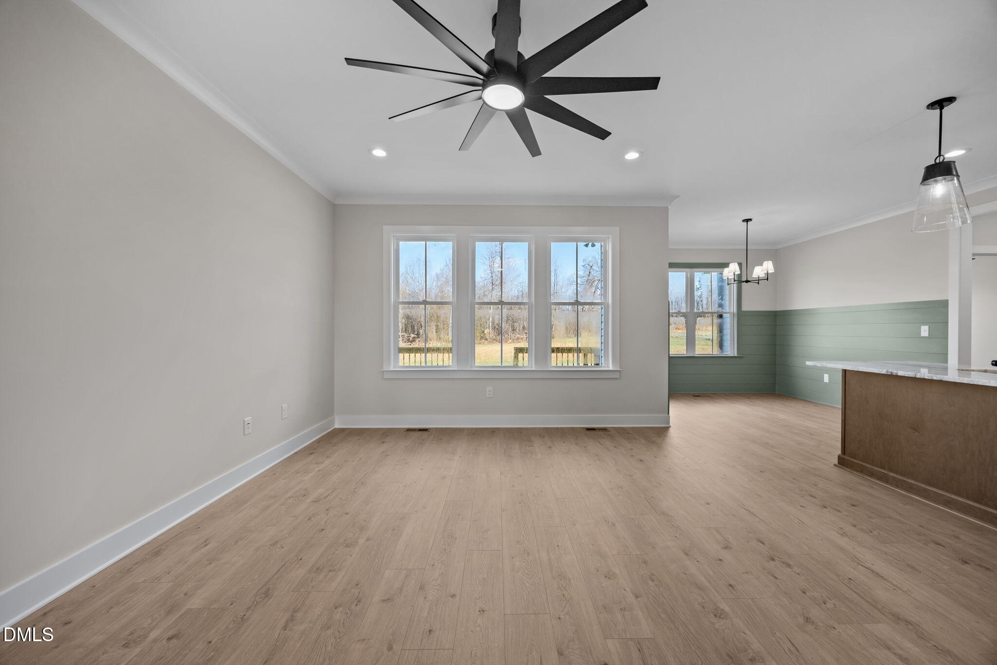 1225 Antioch Church Road Timberlake, NC 27583 - Photo 11 of 45 a view of an empty room with a window and wooden floor