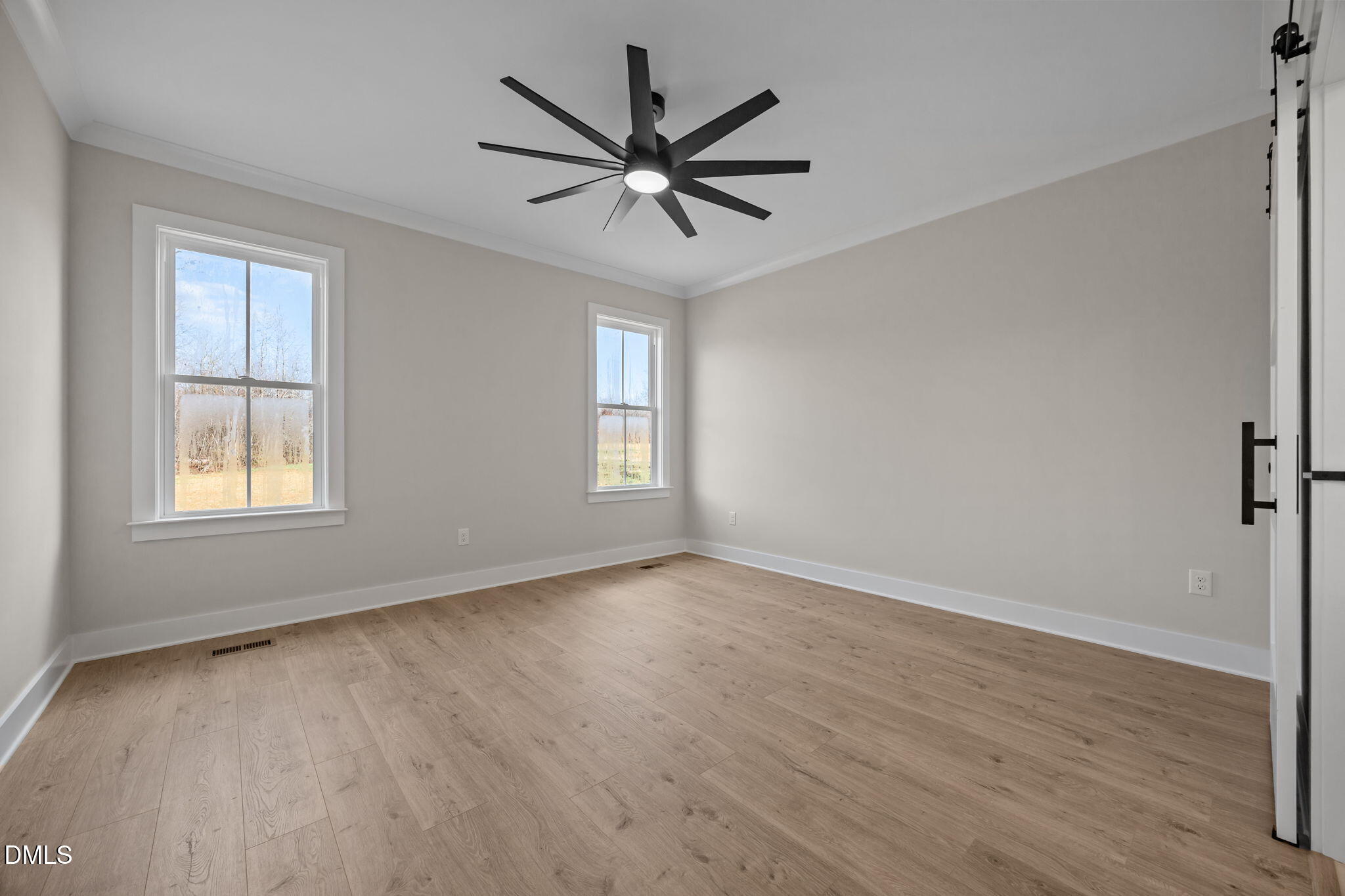 1225 Antioch Church Road Timberlake, NC 27583 - Photo 19 of 45 a view of a livingroom with a ceiling fan and wooden floor