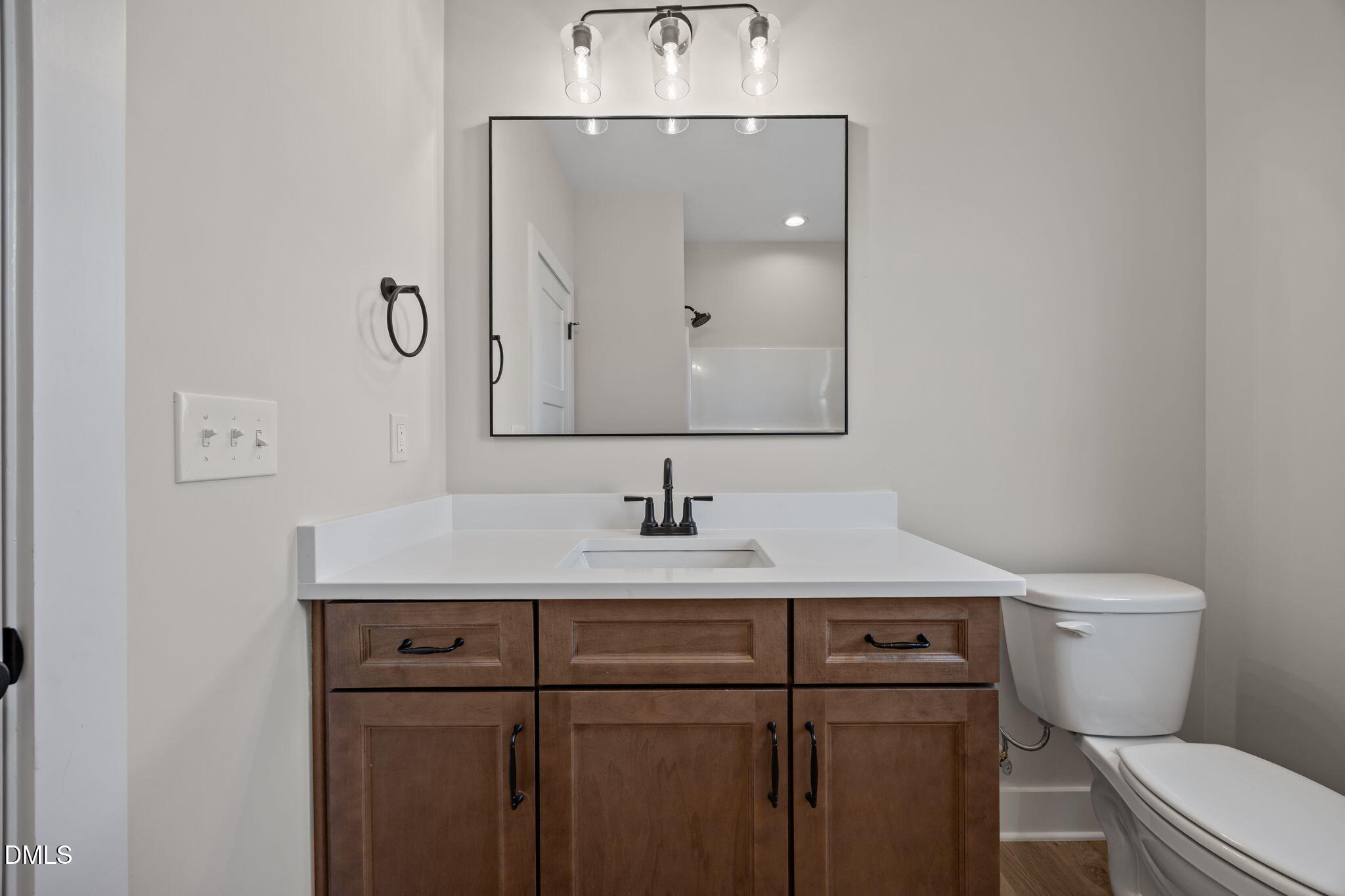 1225 Antioch Church Road Timberlake, NC 27583 - Photo 32 of 45 a bathroom with a toilet a sink and mirror