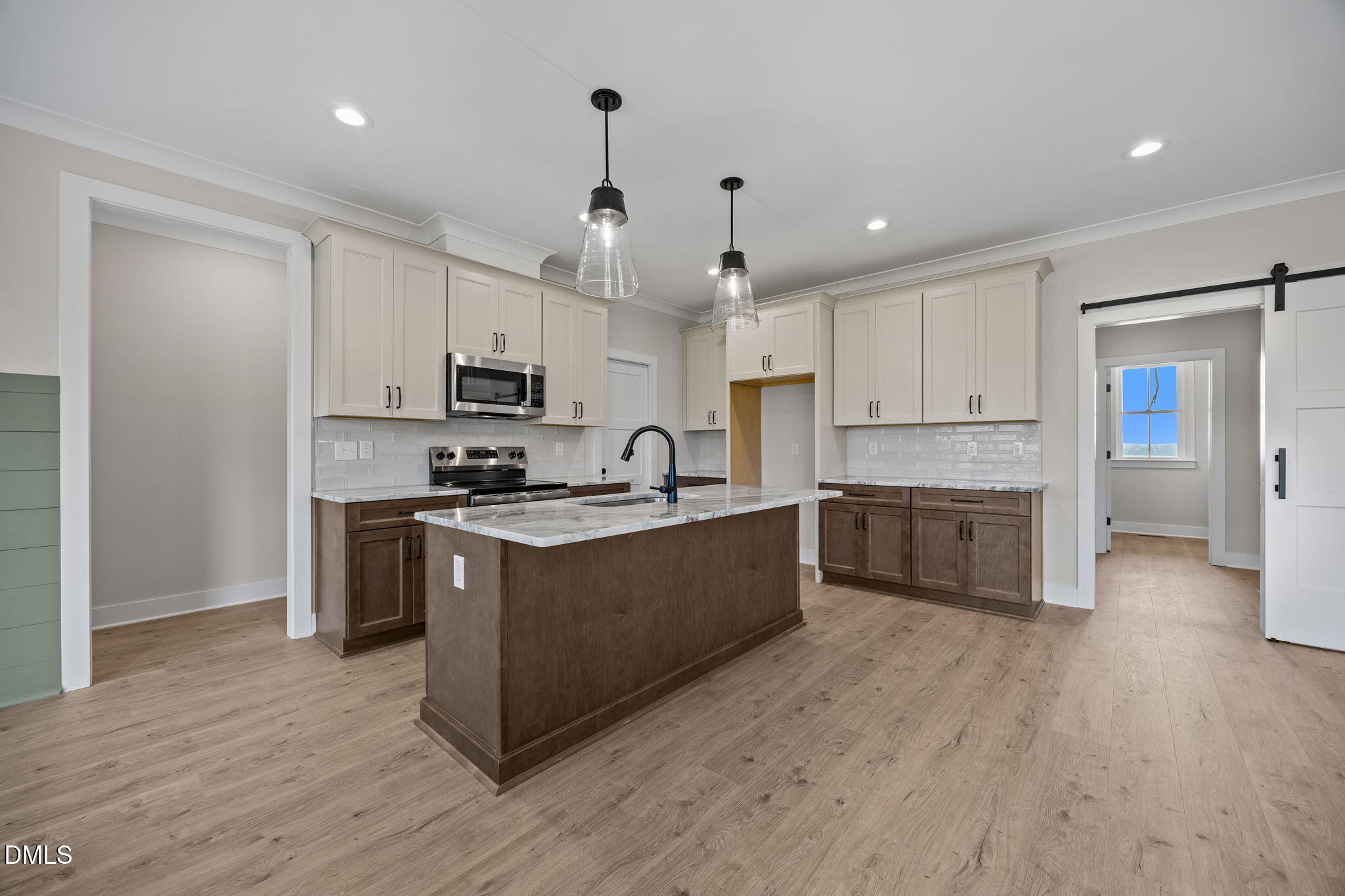 1225 Antioch Church Road Timberlake, NC 27583 - Photo 6 of 45 a large kitchen with stainless steel appliances sink a microwave and cabinets