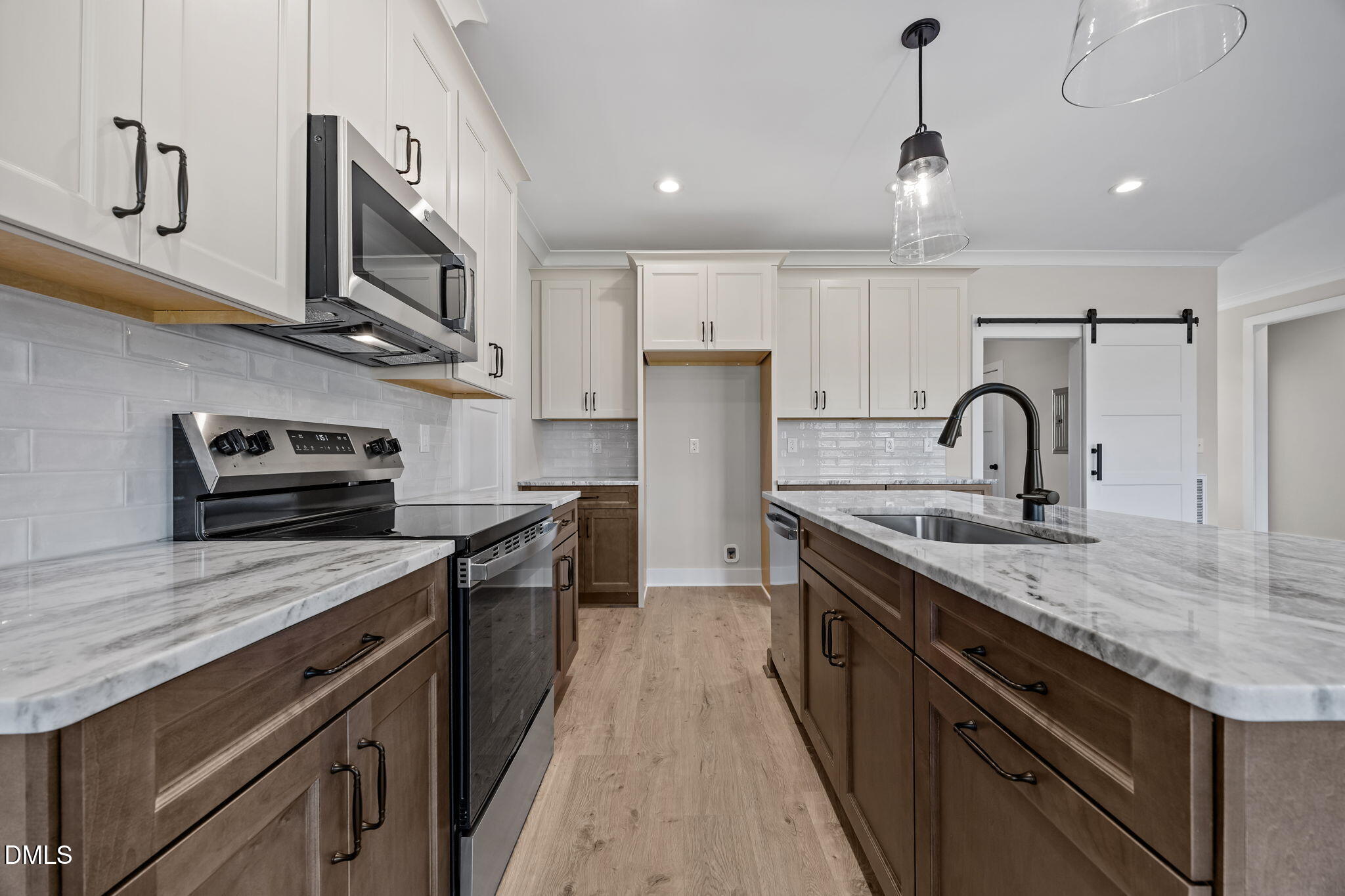 1225 Antioch Church Road Timberlake, NC 27583 - Photo 7 of 45 a kitchen with stainless steel appliances granite countertop a stove a sink and a microwave