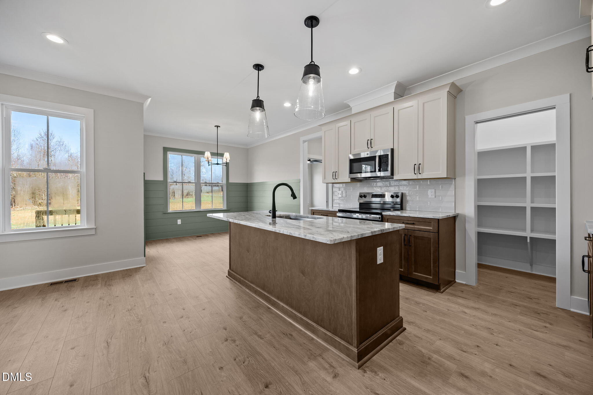1225 Antioch Church Road Timberlake, NC 27583 - Photo 8 of 45 a large kitchen with stainless steel appliances granite countertop a large stove a sink dishwasher and a microwave oven with wooden floor