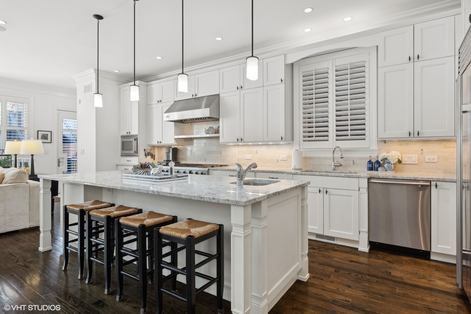 1429 West Cullom Avenue Chicago, IL 60613 - Photo 12 of 53 a kitchen with granite countertop white cabinets stainless steel appliances and a dining table