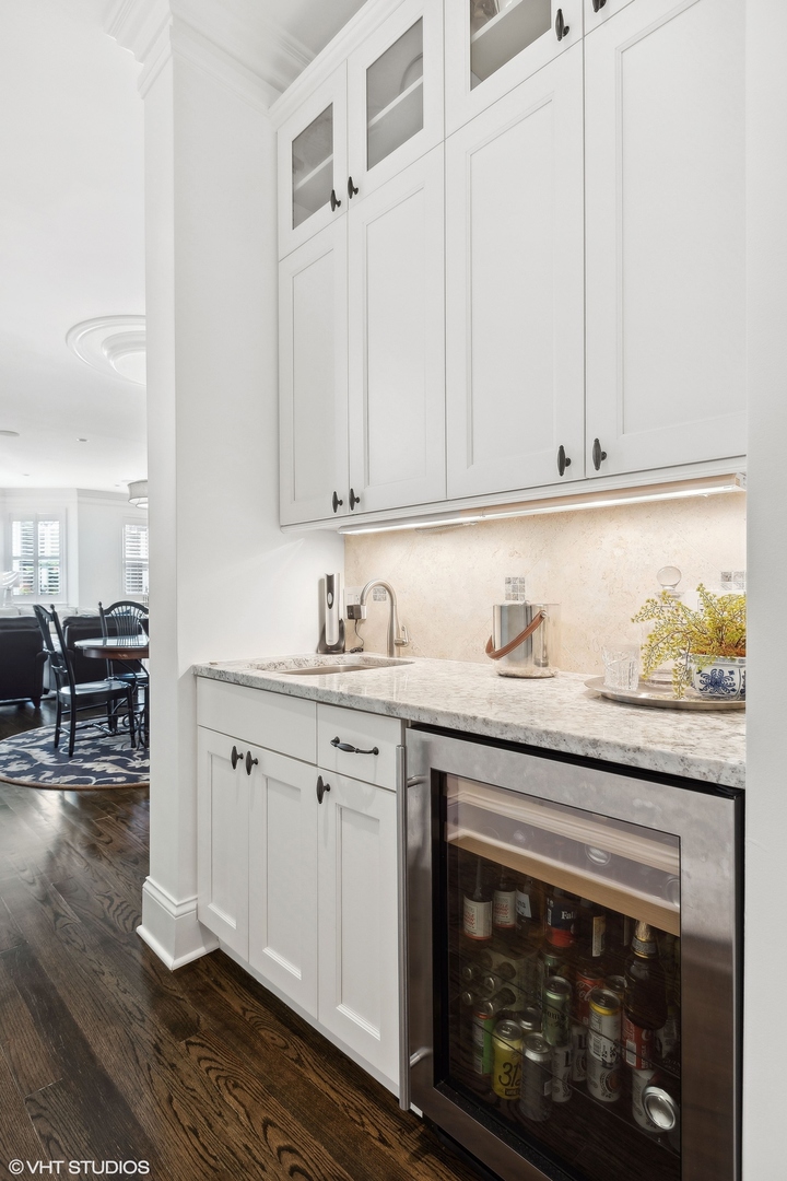 1429 West Cullom Avenue Chicago, IL 60613 - Photo 17 of 53 a kitchen with granite countertop cabinets stainless steel appliances and a wooden floor