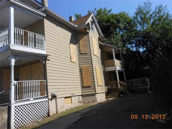 49-51 Rutledge Avenue Springfield, MA 01105 - Photo 2 of 4 a view of a house with a small yard and wooden fence