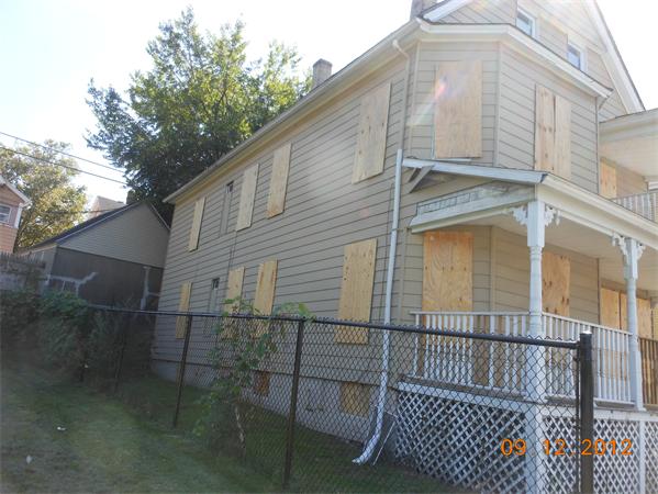 49-51 Rutledge Avenue Springfield, MA 01105 - Photo 4 of 4 a view of a brick house with a small yard