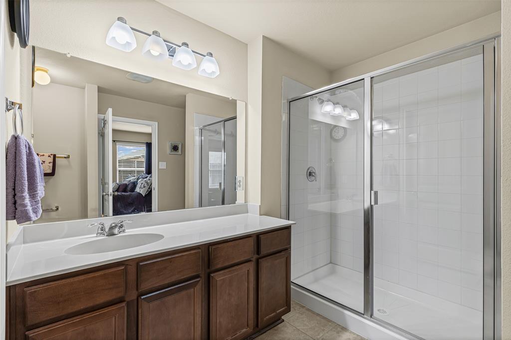 1104 Ruby Court Princeton, TX 75407 - Photo 9 of 40 a bathroom with a double vanity sink mirror and shower