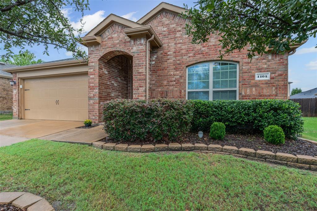 1104 Ruby Court Princeton, TX 75407 - Photo 16 of 40 a front view of a house with a garden