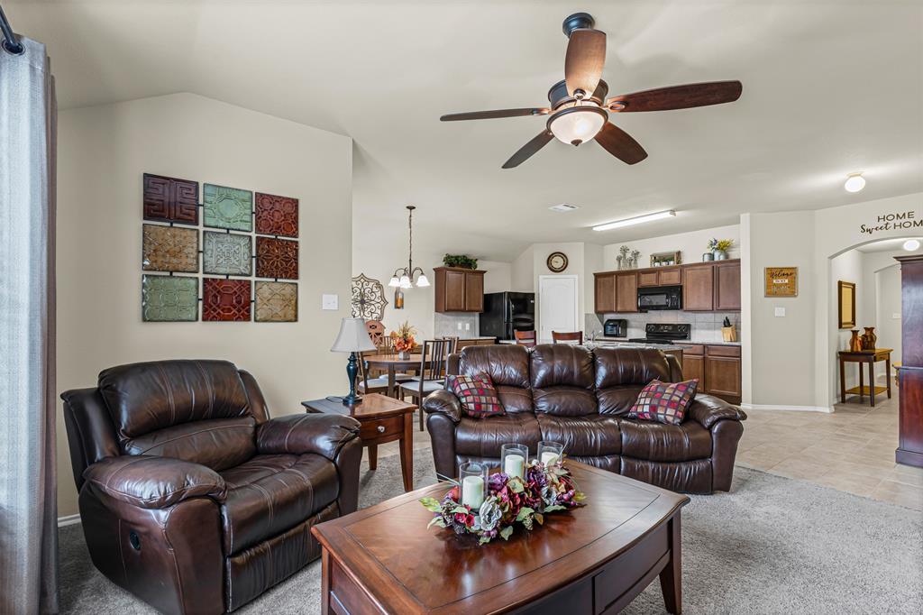1104 Ruby Court Princeton, TX 75407 - Photo 22 of 40 a living room with furniture kitchen view and a chandelier