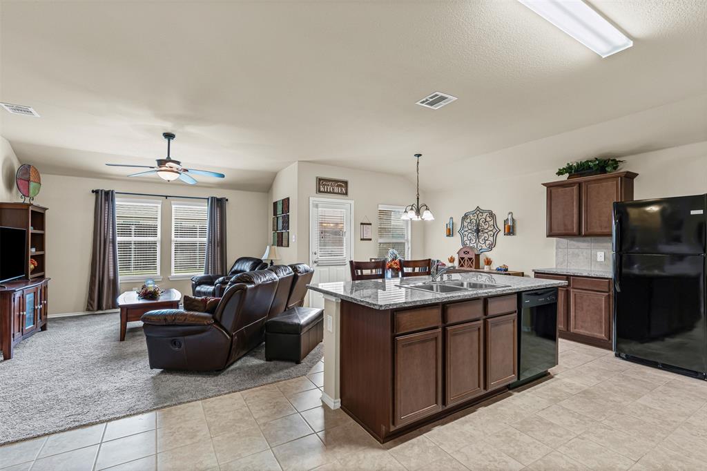 1104 Ruby Court Princeton, TX 75407 - Photo 39 of 40 a living room with granite countertop furniture a flat screen tv and kitchen view