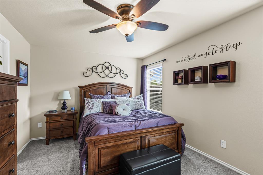 1104 Ruby Court Princeton, TX 75407 - Photo 31 of 40 a bedroom with a large bed and a tv